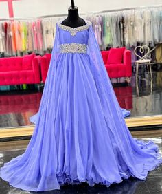 The Samantha Blake 1023 Girls Long Cape Sleeve Pageant Dress is perfect for any special occasion. The crystal cut out back and A line silhouette add a touch of elegance to the chiffon material. With long cape sleeves flowing from a cap sleeve, your child will feel like a true princess in this beautiful dress. Perfect Unique look for Pageants! Sizes: 2-16 Colors: Periwinkle Elegant Purple Pageant Dress, Organza Evening Dress With Fitted Bodice For Pageants, Purple Embellished Pageant Dress, Purple Embellished Dress For Pageant, Floor-length Organza Evening Dress For Pageant, Purple Evening Dress For Pageant And Prom Season, Purple Evening Dress For Pageant During Prom Season, Purple Evening Dress For Prom Season And Pageants, Embellished Georgette Dress For Banquet