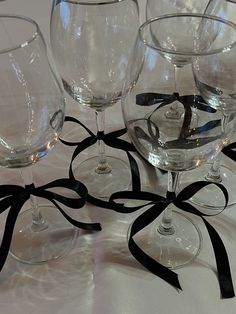 four wine glasses with black ribbons on them