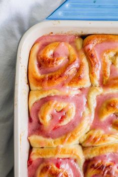 a pan filled with cinnamon rolls sitting on top of a table