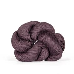 a skein of yarn with the words plum brown on it and an image of a ball