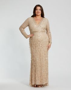 Turn heads in our Embellished Fringe Long Sleeve Gown. This stunning dress features intricate embellishments and elegant fringe, perfect for special occasions. Mac Duggal Embellished mesh fabric (100% polyester) Fully lined through bodice and skirt V-neckline Long sleeves Beaded waist/neckline Fringe detail throughout Concealed back zipper Approx. 60" from top of shoulder to bottom hem Available in Nude Gold Style #94074 Glamorous Evening Dress With Beaded Fringe For Formal Occasions, Glamorous Formal Evening Dress With Beaded Fringe, Glamorous Beaded Fringe Evening Dress For Formal Events, Elegant Evening Dress With Beaded Fringe For Prom, Elegant Beaded Fringe Evening Dress For Prom, Glamorous Floor-length Dress With Beaded Fringe, Elegant Beaded Fringe Evening Dress For Formal Occasions, Glamorous Embellished Mother Of The Bride Dress For Gala, Evening Floor-length Dress With Beaded Fringe