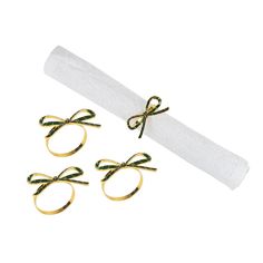 three pairs of gold - plated metal rings tied with green string on white paper