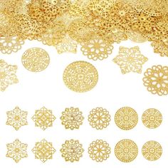 gold filigrees are laid out on a white surface