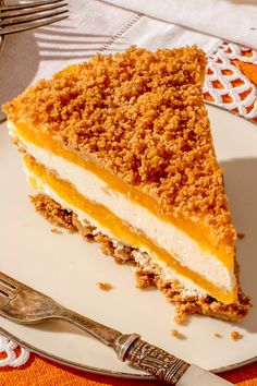 a piece of cake sitting on top of a white plate next to a fork and knife