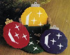 three christmas ornaments sitting on top of a wooden table