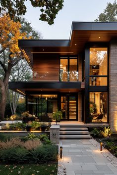 a modern house with large windows and steps leading up to it