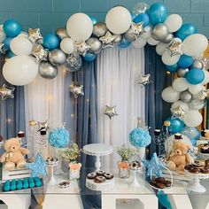 a table topped with balloons and desserts