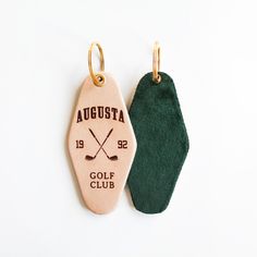 two wooden tags with golf clubs on them, one is green and the other is white