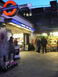 people are standing in front of the underground market