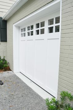 a white garage door in front of a house