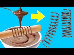 chocolate spread being poured into a cup with a wooden spoon and spring coming out of it