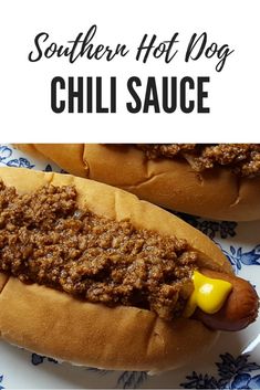 two chili dogs on buns with mustard and ketchup in between the bun