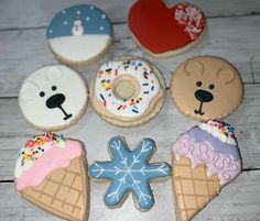 decorated cookies are arranged in the shape of ice cream, donuts, and bears