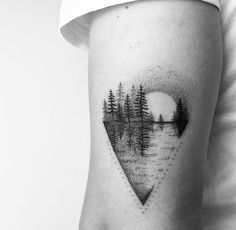 a black and white photo of trees in the shape of a heart on a woman's thigh