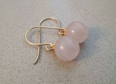 Delicate and tasteful pair of natural Rose Quartz earrings. Each earring is made of a round smooth bead of natural Rose Quartz and a Gold Deeped setting. Each bead is 8.00mm in diameter. If you prefer, we can also prepare these earrings with smaller beads, size 6.00mm. Material: Gold Filled For more earrings: http://etsy.me/2ru2olL Rose Gold Earrings With Round Beads For Gift, Romantic Gifts For Wife, Gemstone Earrings Gold, Horse Necklace, Rose Quartz Earrings, Garnet Jewelry, Garnet Earrings, Gold Filled Earrings, Pet Necklace