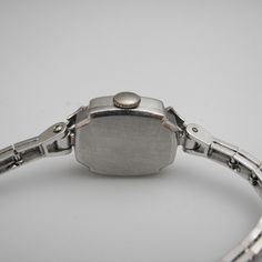 "For sale: (1) g123 14k White Gold Women's Diamond Elgin Watch PLEASE READ ENTIRE DESCRIPTION BEFORE PURCHASING Pre-owned item. Good condition. Please see pictures for details. Sold as is, as seen on pictures. This beautiful ladies Elgin Art Deco watch contains 62 diamonds, all of which are round cut. It is stamped. Specifics: 14k White gold Diamonds: .86TCW Mechanical Length: 5.5 inches Case size with crown: 15.9 mm Lug width: 4mm Please be 100% sure of your purchase before buying, as we do not Classic White Gold Rectangular Jewelry And Watches, Classic Engraved White Gold Jewelry And Watches, Classic Engraved White Gold Jewelry, Elegant Engraved White Gold Watch Accessories, Elegant Collectible Watch With Rectangular Dial, Silver Wedding Watch With Rectangular Dial, Silver Rectangular Dial Watches For Wedding, Collectible White Gold Elegant Watches, Vintage Rectangular Jewelry With Diamond Hour Markers