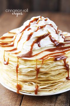 a stack of pancakes covered in caramel syrup and whipped cream