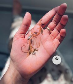 a person holding out their hand with an intricate design on it's palm and fingers