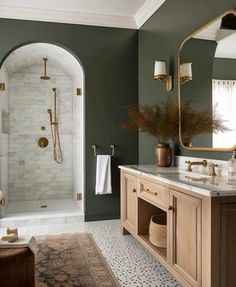 a bathroom with green walls and gold fixtures