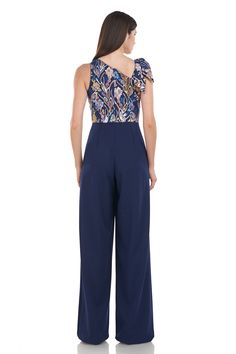 PRODUCT DETAILS Chic in silhouette and mesmerizing in color—our Nova jumpsuit showcases its multi-colored sequins and embroidered patterns on a navy mesh bodice. It features an asymmetric neckline, bow detailing at the shoulder, and finishes with a wide leg palazzo pant made of stretch knit crepe—giving way to its elegant yet soft texture. Zipper opening Jumpsuit silhouette Partially Lined Floor length Jumpsuit Sequin embroidered mesh with stretch crepe Sleeveless Asymmetric Neck Bow Detail 100% Jumpsuit Sequin, Palazzo Jumpsuit, Embroidered Patterns, Palazzo Pant, Wide Leg Palazzo Pants, Neck Bow, Asymmetric Neckline, Stretch Crepe, Palazzo Pants