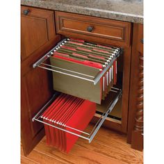 the drawers are full of files and folders in this kitchen cabinet door pullout