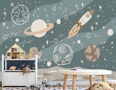 a child's room with space themed wallpapers and toys on the floor