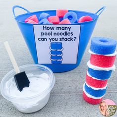 a bucket full of pool noodles next to a cup of water with a brush in it