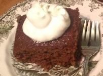 a piece of chocolate cake with whipped cream on top