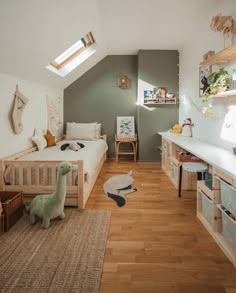 a child's bedroom with wooden floors and green walls, white bedding and shelves