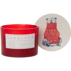 a red candle sitting next to a coaster with an image of a polar bear on it