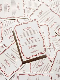 a pile of white and red wedding cards on top of each other with the words to whom