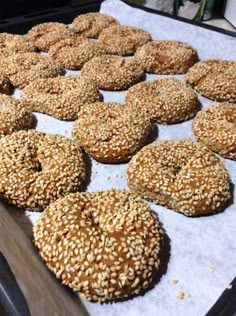 sesame seed bagels are lined up on a baking sheet and ready to be baked