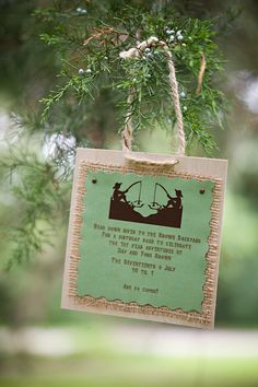 a wooden ornament hanging from a tree with a poem on it's side