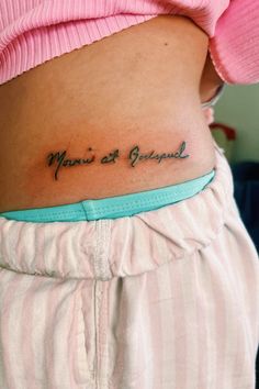 a woman's stomach with the words mama and grandpa tattooed on her lower back