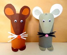 two paper mice are standing next to each other