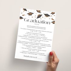 a hand holding up a graduation program for students to use on the front page of a book