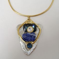 Large Chunky Blue & Crystal Pendant Necklace By J. Jansen. Unique Necklace In Clear Crystal & Shades Of Blue Colored Semi-Precious Stones. Plated In 24 Kt Gold & A Non-Tarnish Silver Finish. Adjustable Length From Approx. 14" To 16". New With Tag. 100 407 263 Luxury Blue Jeweled Necklaces, Modern Blue Pendant Jewelry, Blue Costume Jewelry With Stones, Luxury Blue Pendant Necklace, Modern Blue Gemstone Necklace, Blue Jeweled Costume Necklaces, Blue Jeweled Costume Jewelry Necklaces, Elegant Blue Necklaces With Gemstone Accents, Blue Costume Jewelry Necklaces With Jewels