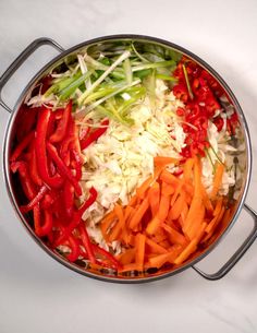 vegetables are mixed together in a large pot