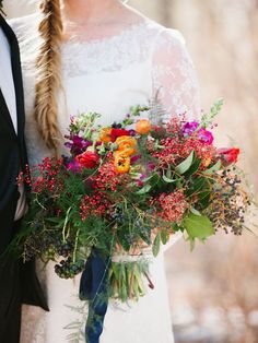 the bride and groom are holding their bouquets