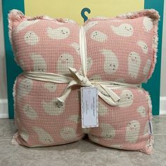 two pink pillows with white teddy bears on them