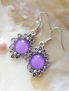 A beautiful pair of silver tone metal earrings decorated with a purple glass cabochon. If you want to replace hooks to silver ones please make a custom order. Such change costs additional 5 euro. Delivery to EU member states takes about 7 working days and 14 working days to all other countries. The product is delivered by mail. If you have any questions, I'm always happy to help and clarify all the details. Thank you for visiting my store! Victorian Earrings, Earrings Purple, Purple Earrings, Silver Christmas, Purple Glass, Christmas Earrings, Cluster Earrings, Metal Earrings, Earrings Silver