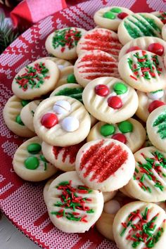 christmas cookies decorated with candy and frosting on a plate