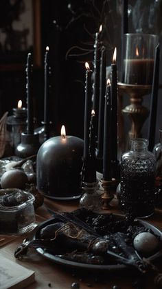 a table topped with lots of black candles