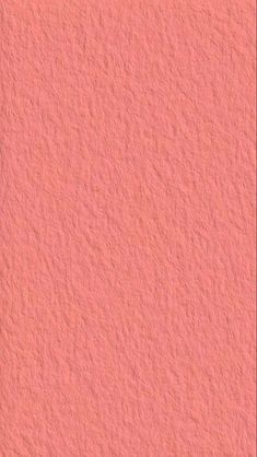 an orange wall with some sort of textured surface that looks like it has been painted pink