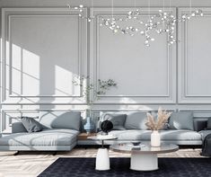 a living room filled with furniture and a chandelier hanging over the top of it