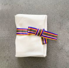 a white napkin with a colorful ribbon tied around it