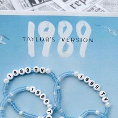 two bracelets made out of plastic beads with the words 1989 written in white letters