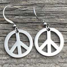 "Peace earrings, Stainless steel non tarnish. Peace earrings cut from thick shiny Stainless Steel Earwires of Stainless Steel Fish Hook style Stainless Steel Earwires Circle Outline charm measures just over 3/4\" wide (18mm) Stainless steel / non-tarnish / no plating See Care and Wear Instructions on home page for more information on Stainless Steel jewelry Matching Pendants in two sizes also available ⓒ All Designs and Images are copyrighted by Be Inspired UP. All Rights Reserved." Wooden Peace Sign Ear Rings, Matching Pendants, Jewelry Matching, Antler Earrings, Peace Earrings, Circle Outline, Blue Sea Glass, Copper Earrings, Steel Jewelry