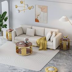 a living room with white couches and yellow tables on the floor next to a potted plant