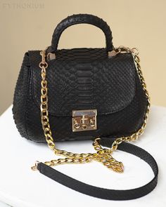 Women's python skin handbag Elegant black genuine python leather handbag remains an iconic bag season after season and very rare. This masterpiece is crafted from the highest quality exotic python snakeskin leather. The model will become a worthwile companion both at social events and in everyday life. With this luxurious snakeskin handbag you will be the center of attention!The golden chain has the option of detaching the strap and can be used as a top handle bag. Handbag in stock, order proces Snake Skin Handbag, Reptile Skin, Python Skin, Snake Skin Bag, Iconic Bags, Social Events, Python, Snake Skin, Reptiles